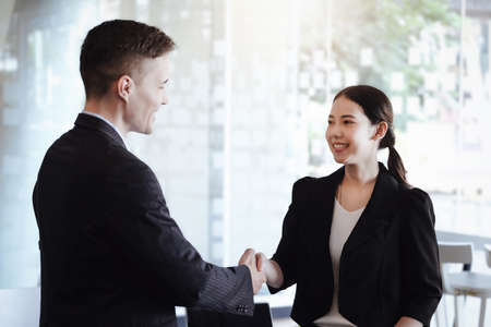 Congratulations, the owners of 2 companies are holding hands to congratulate them on their joint...