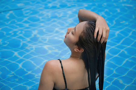 Beautiful southeast asia woman in pool relaxing.の写真素材