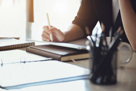 Business owners are using a computer tablet. in managing financial statements to adjust the companys...
