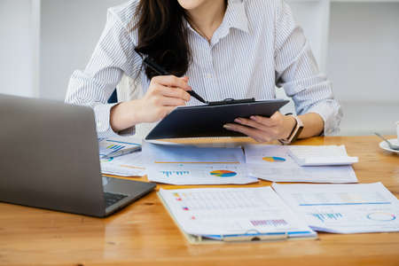 Work from home. Start a small business owner by using pens and documents, personal business income and computers to work.の写真素材