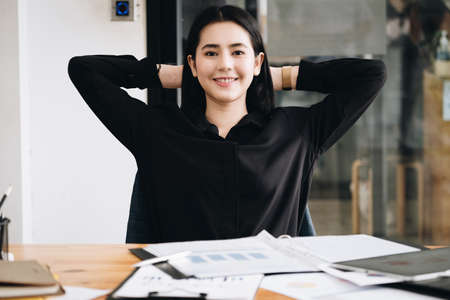 The female employee shows a smiley face after completing the task at the end of the time.の写真素材