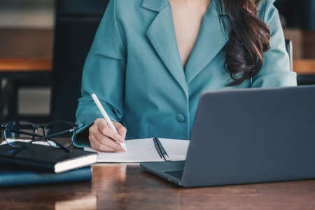 Investment concepts, businesswomen use document and computers to analyze stock markets, quantitative...