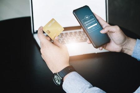Online Shopping and Internet Payments, Asian man are using their credit card and mobile phone to...
