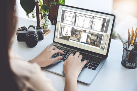 Architects or designers engineers, interior designers, female designers are using home interior design computer programs to send clients to their clients.の写真素材