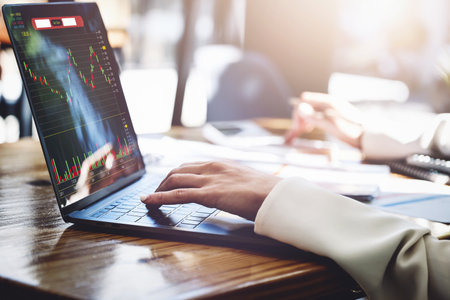 Financial and investment planning concept, female businesswoman using computer to analyze charts to...