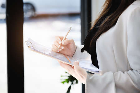 Young economists or accountants or financiers and investors are reviewing budget documents to study...
