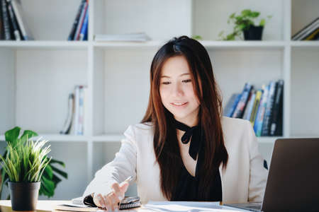 economists and accountants , data analysts are using calculators to calculate budgets and investments using statistical documents and computers to work at their desks.の写真素材