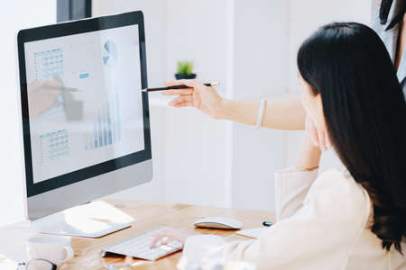 Consultation, Discussion, Marketing and Investment concept, female employee with pen is pointing at...