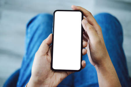 Editing, Advertising Media, Creative Work, Close up woman hand holding white phone on blank screen .の写真素材