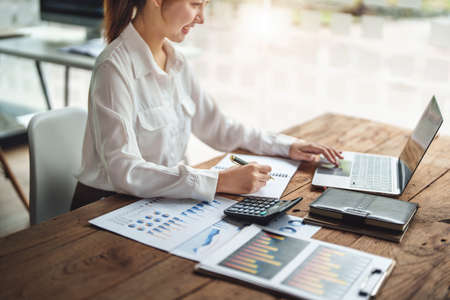data analysis, plan, marketing, accounting, audit, asian business woman hoding pen of planning marketing using statistical data sheet and computer to present marketing plan project at meeting.の写真素材