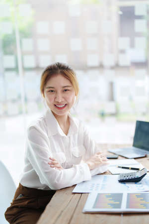 data analysis, plan, marketing, accounting, audit, Portrait of asian business woman planning marketing using statistical data sheet and computer to present marketing plan project at meeting.の写真素材