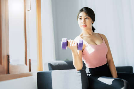 stress relief, , breathing exercises, meditation, portrait of Asian healthy woman lifting weights to...