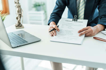 Law, Consultation, Agreement, Contract, Attorney or Lawyer holding a pen is consulting with a client to explain the pattern of answering questions before going to court to decide a lawsuitの写真素材