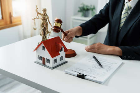 Focus at gavel, Attorney or Lawyer holding a pen is consulting with a client to explain the pattern...