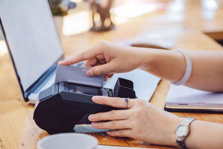 card swipe machine, cyber security, convenience of payment, staff use EDC card machine to swipe customer credit card to make in-store purchases.の写真素材