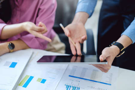 Concept of the impact of warring countries, male economists are using tablets to consult with...