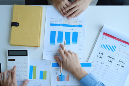 Teamwork concept, consultation, economist pointing budget, finance and investment documents, discussing and planning finances with advisors in conference room.の写真素材