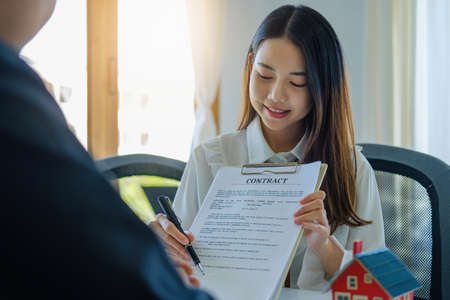 Guarantee, Mortgage, agreement, contract, Signing, Male client holding pen to reading agreement...