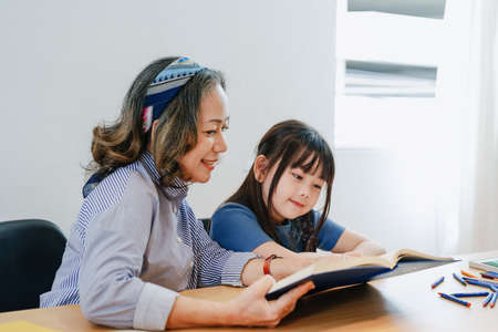 Asian portrait, grandchild granddaughter grandma grandmother and granddaughter happily join in activities to enhance skills for grandchildren.の写真素材