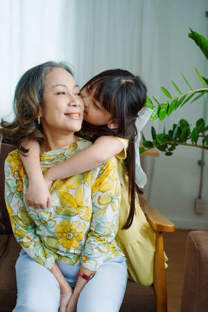 Asian portrait, grandma and granddaughter doing leisure activities and hugging to show their love...