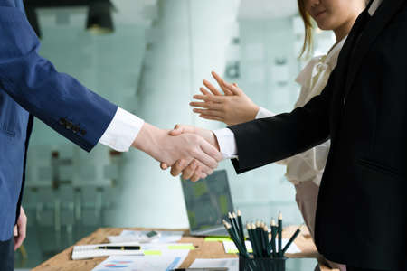 Asian entrepreneurs handshakes to congratulate the agreement between the two companies to enhance investment and financial strength. deal concept.の写真素材