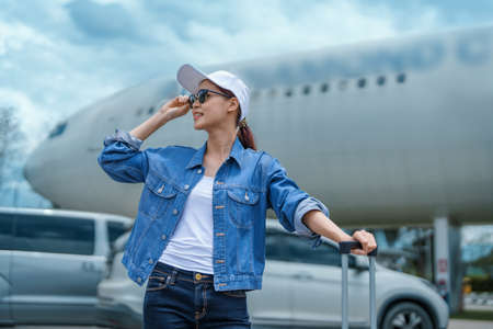 travel business Portrait of an Asian woman showing joy while waiting for a flight.の写真素材