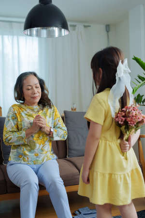Asian portrait, grandma and granddaughter doing leisure activities and hugging to show their love...