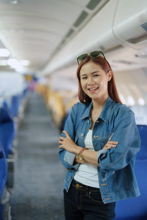 travel business Portrait of an Asian woman showing joy while waiting for a flight.の写真素材