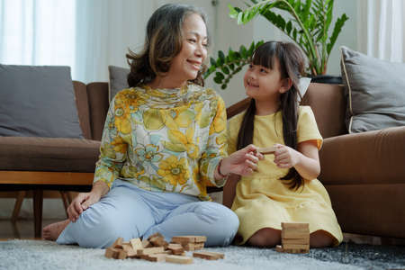 Asian portrait, grandma and granddaughter doing leisure activities and hugging to show their love...