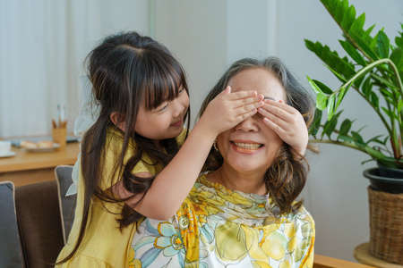 Asian portrait, grandma and granddaughter doing leisure activities and hugging to show their love...