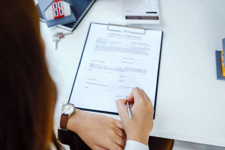 Guarantee, Mortgage, agreement, contract, Signing, Male client holding pen to reading agreement...
