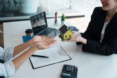 Guarantee, mortgage, agreement, contract, sign, real estate agent delivers the house to the customer after signing important contract documents.の写真素材