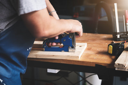 Entrepreneur Woodwork holding a Tacker to assemble the wood pieces as the customer orderedの写真素材