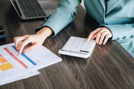 economist, accountant or financier And Asian investors are using calculators to calculate document...