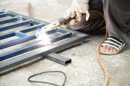 The welder is welding the steel structure to add to the houseの写真素材