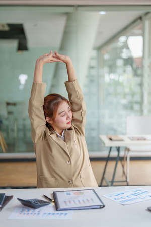 Burnout Syndrome. Portrait of Asian Business Woman feels uncomfortable working. Which is caused by stress, accumulated from unsuccessful work And less resting body. Consult a specialist psychiatristの写真素材