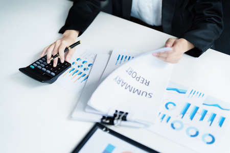 accountant, Auditor, Self-Employed, Finance and Investment, tax calculation and budget, Asian female entrepreneur using a calculator to calculate. Company business results documentの写真素材