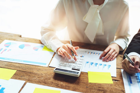financial, Brainstorming, Data Analysis, Planning, Marketing and Accounting, Economist using calculator to calculate investment documents with partners on profit taking to compete with other companiesの写真素材