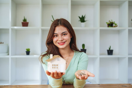 The customer holds the house model and keys after agreeing to invest in the housing purchase.の写真素材