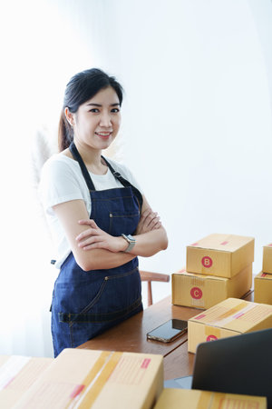 Starting small business entrepreneur of independent Asian woman smiling using tablet computer with...