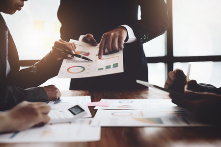 Planning to reduce investment risks, the image of a group of businesspeople working with partners is...