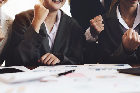 Businesspeople showing success with sales that have exceeded their targets.の写真素材