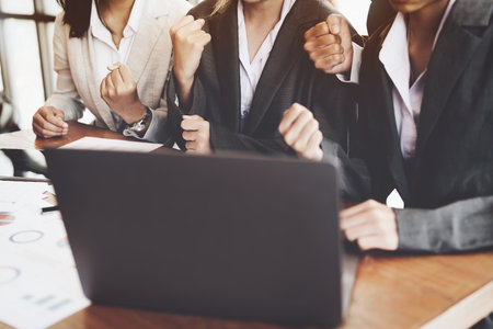 Businesspeople showing success with sales that have exceeded their targets.