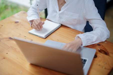 woman using a notebook and computer during a video conference, e learning conceptsの写真素材