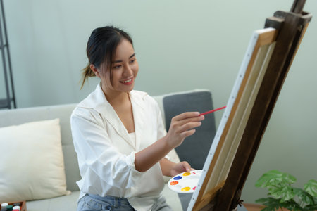 Portrait of an Asian woman designing art in her spare timeの写真素材
