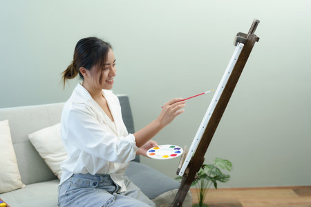 Portrait of an Asian woman designing art in her spare timeの写真素材