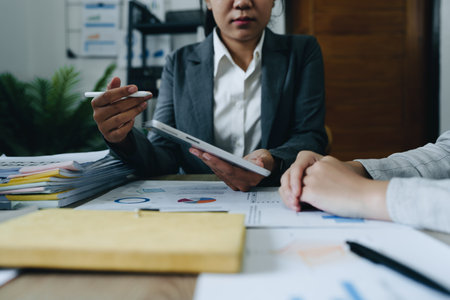 Asian entrepreneurs and business people meeting in a conference room in business planning, financial budget and investment risk assessment to analyze customer groups to increase company growth.の写真素材