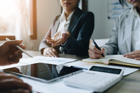 Asian entrepreneurs and business people meeting in a conference room in business planning, financial budget and investment risk assessment to analyze customer groups to increase company growth.の写真素材