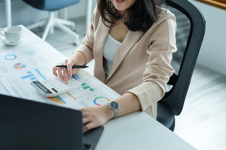 Accountants, Asian auditors are using calculators and computers to review annual tax budgets to submit information to the IRSの写真素材