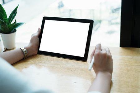 Young Asian women are using a white screen tablet computer that can add text or images to it.の写真素材